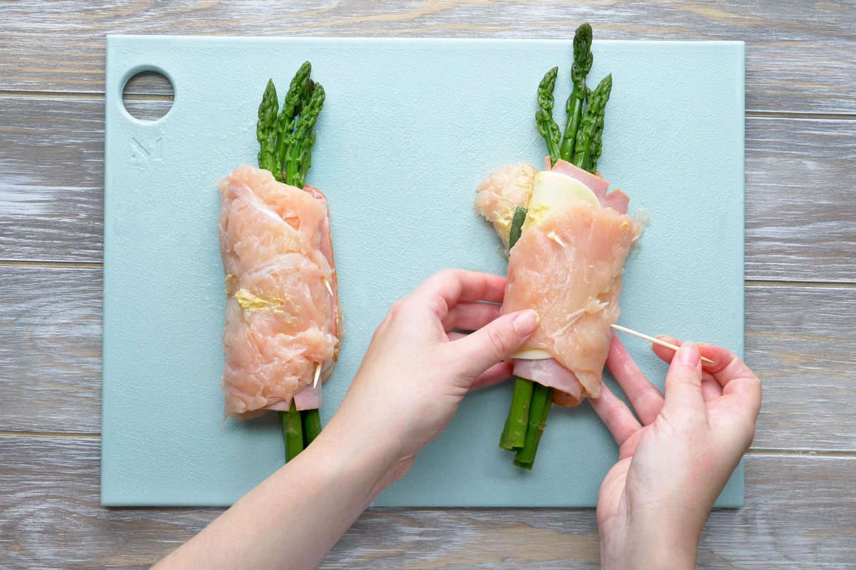 Fold chicken over asparagus; secure with toothpicks.