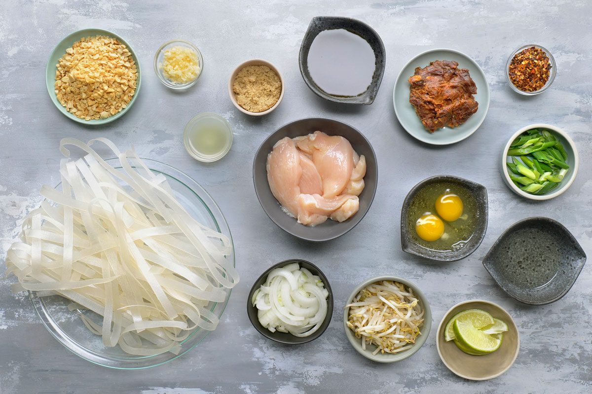 overhead shot of Chicken Pad Thai ingredients placed over gray background