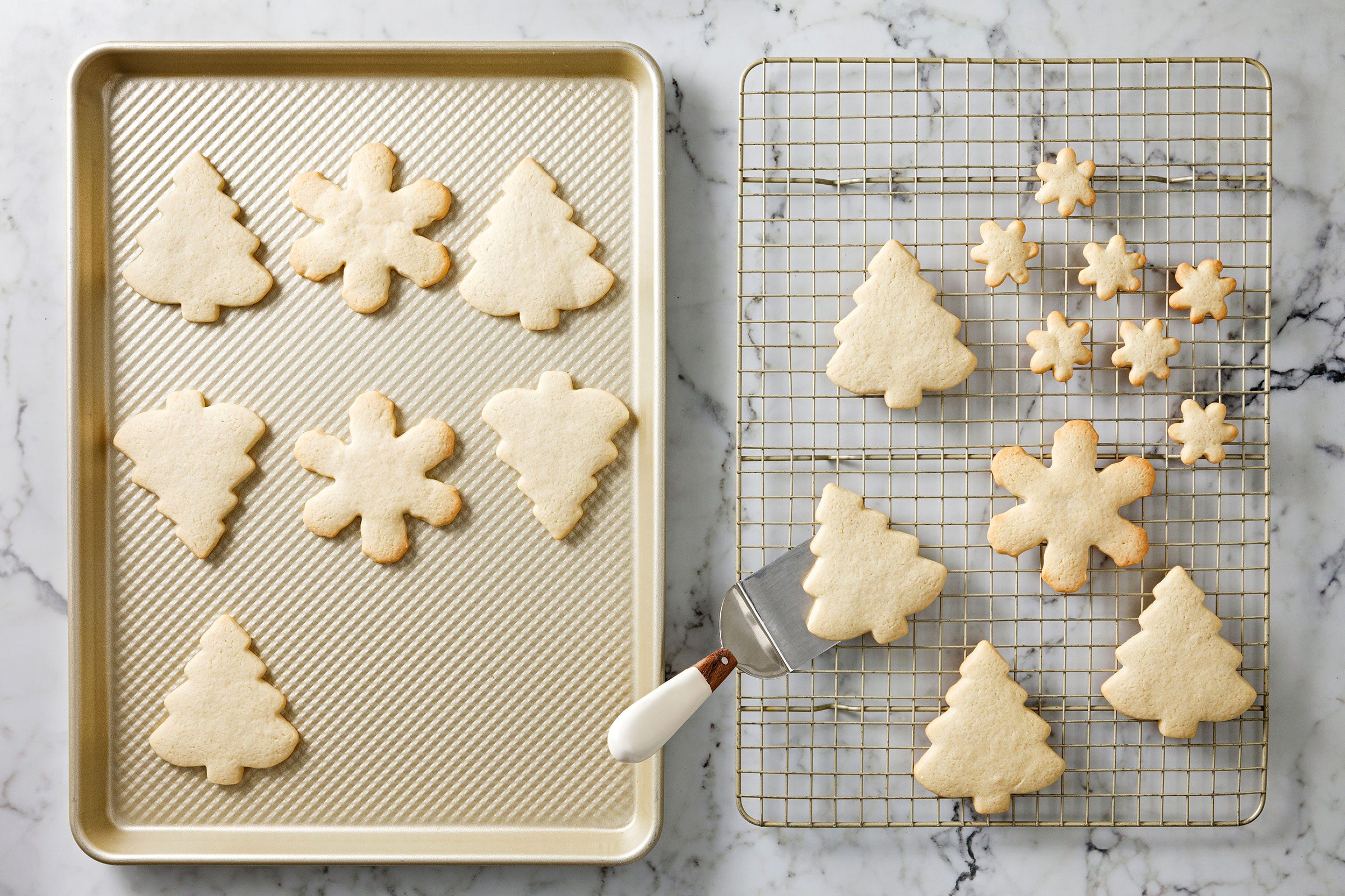 Golden brown baked cookies placed on baking tray and being cooled on wire racks