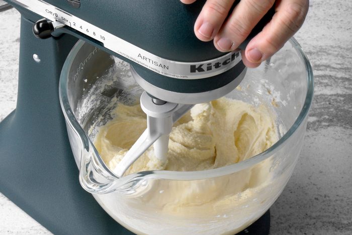 Butter and sugar mixed in a large bowl in a mixer