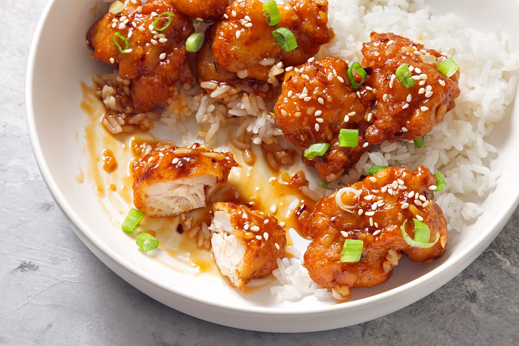 3/4th shot of copycat panda express orange chicken served with rice