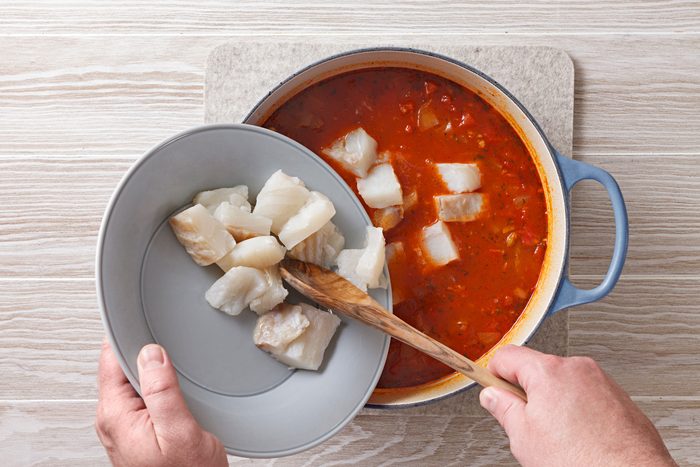 Stir in diced tomatoes, clam juice, broth and white wine.