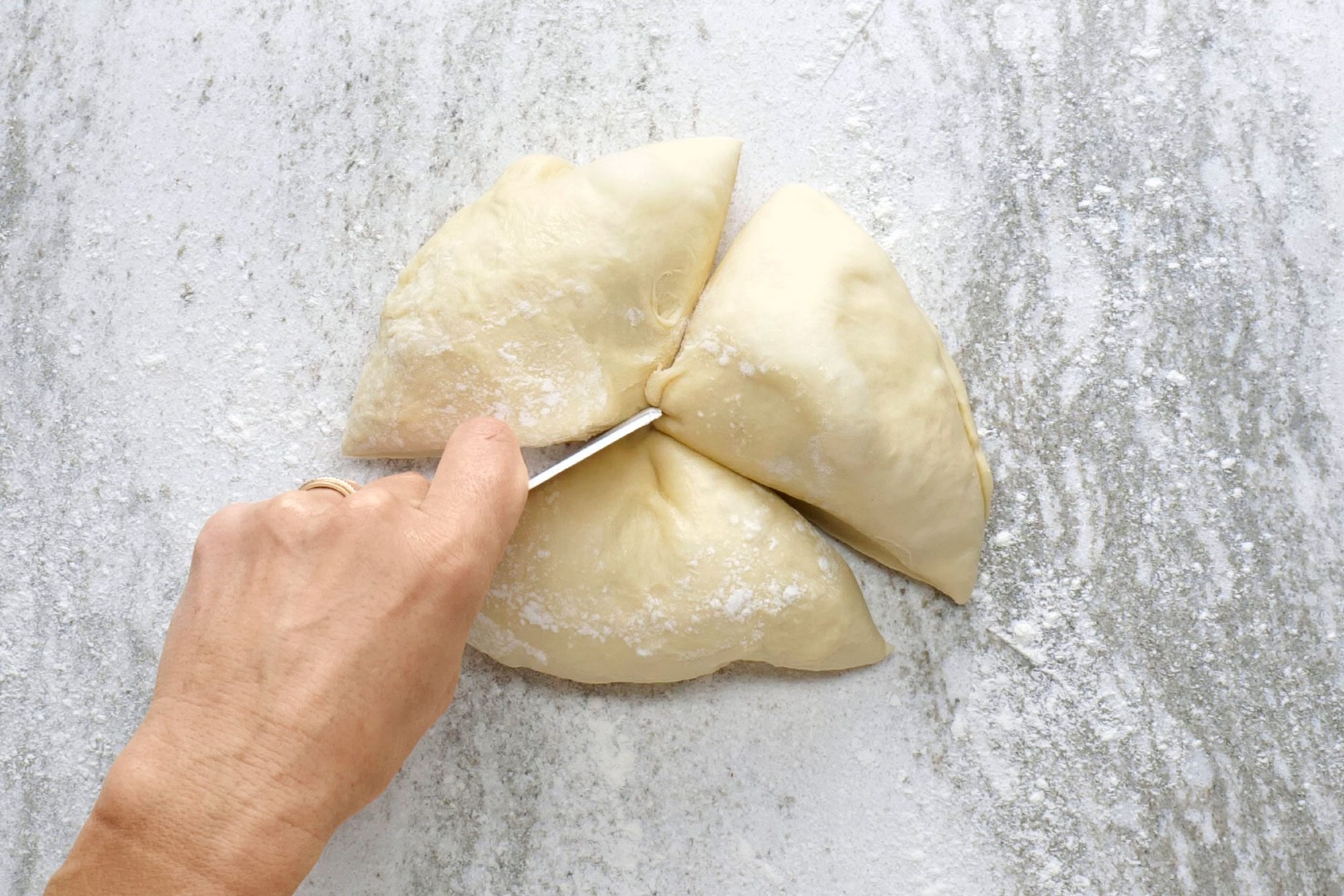 Punch down the dough and divide it into three equal pieces