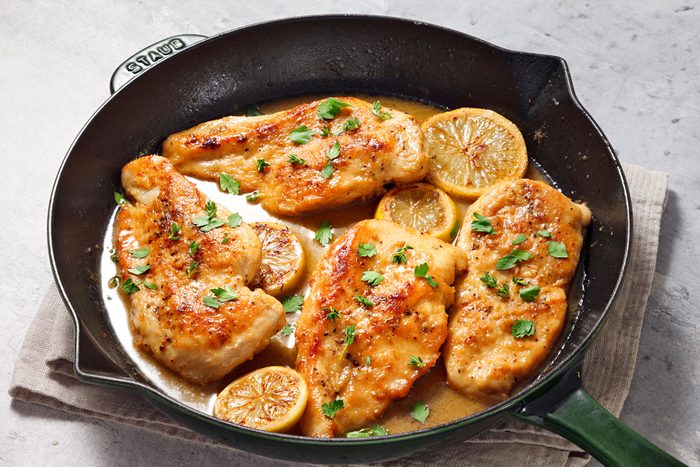 Lemon Chicken in a skillet sprinkled with some parsley