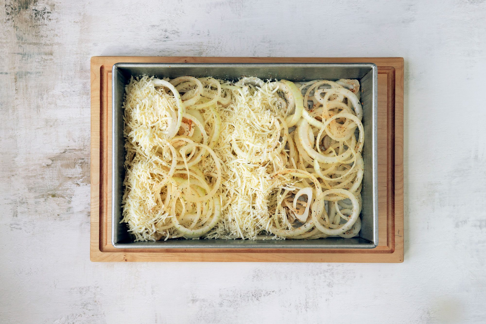 Pour the spice blend over the onions; toss the onions and spices together