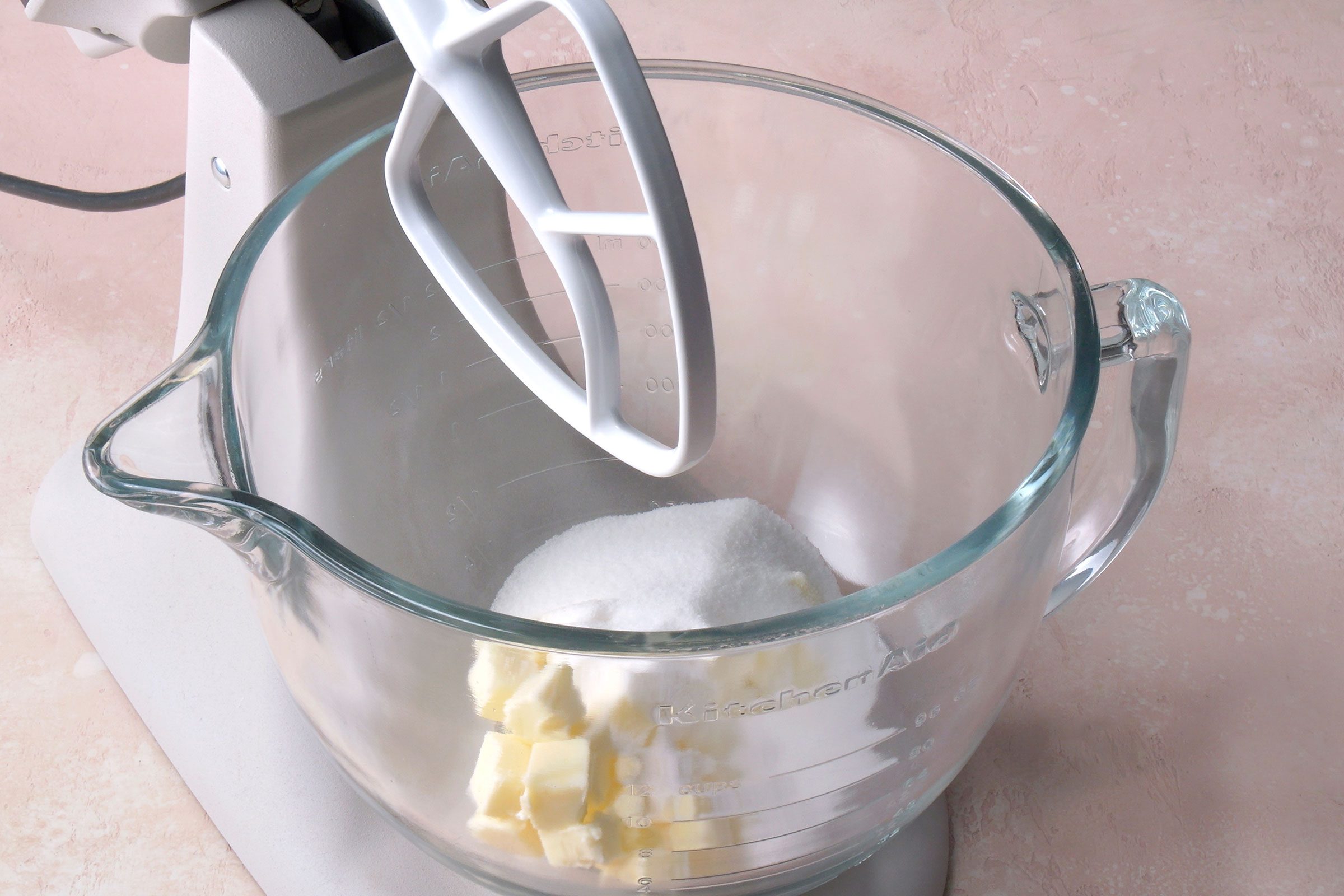 Beating butter and sugar in a glass bowl