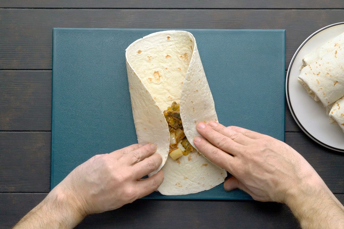 To assemble, place 1/2 cup off-center on each tortilla. Fold up edge nearest filling; fold in both sides and roll up.