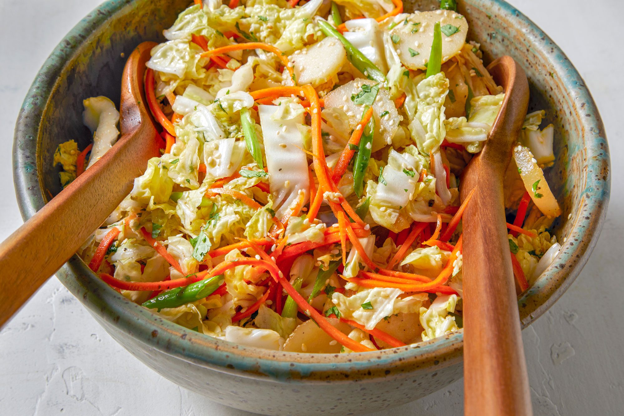 Chinese Coleslaw served in a bowl with two spoons