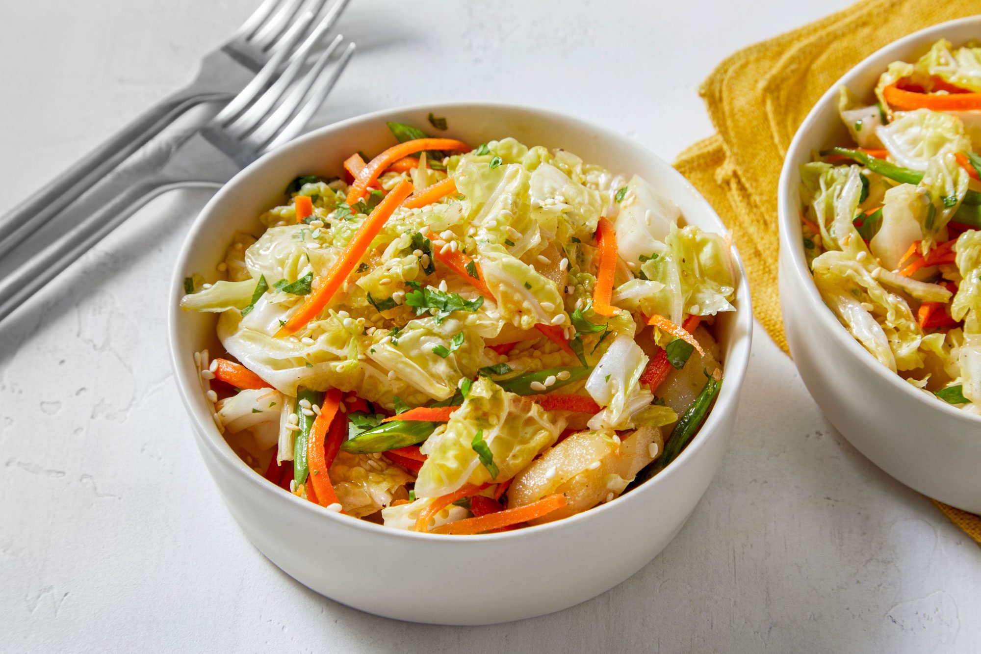 Chinese Coleslaw served in bowls with forks on the side 