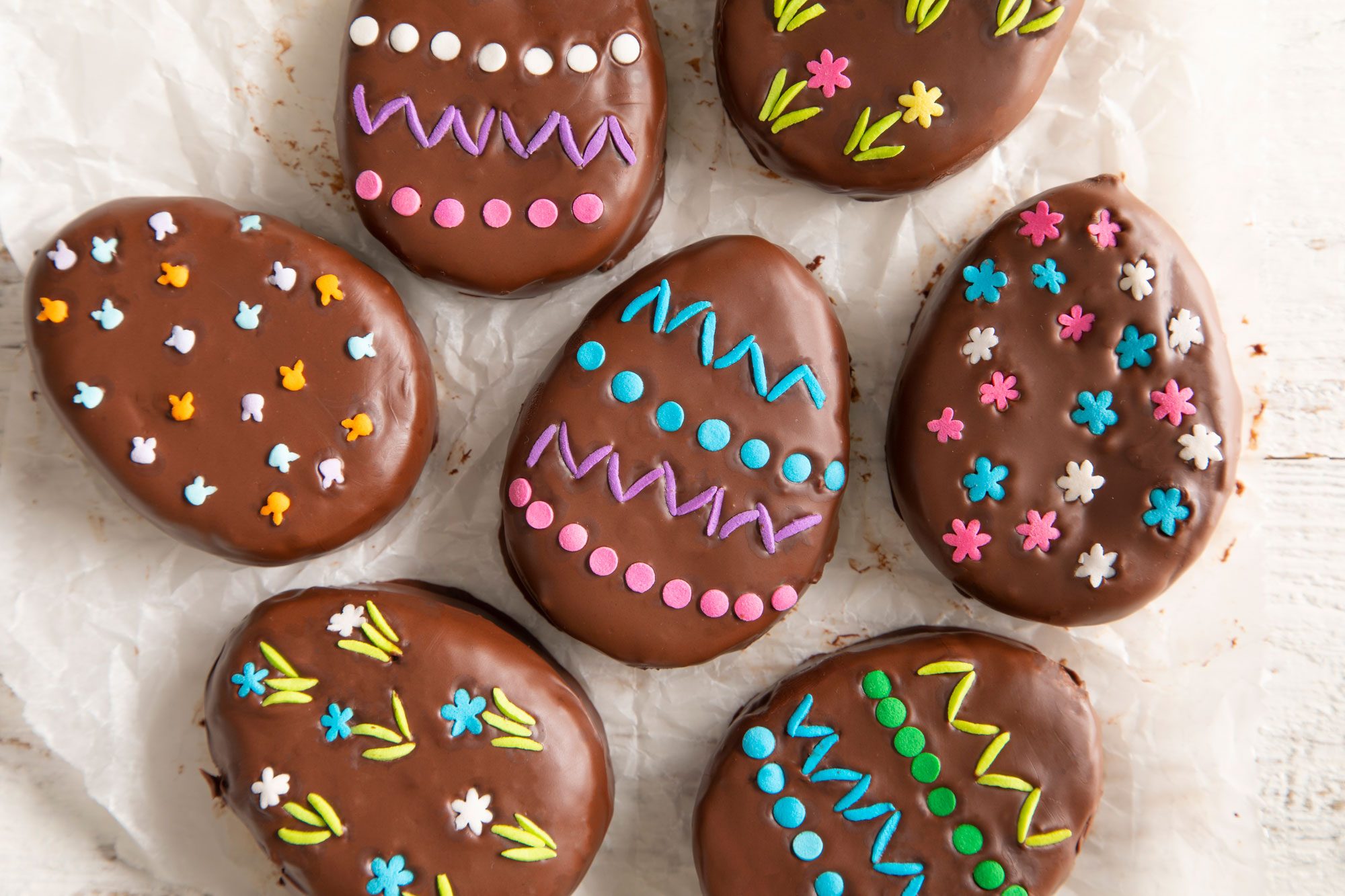 Delicious chocolate-covered Easter eggs on a baking sheet