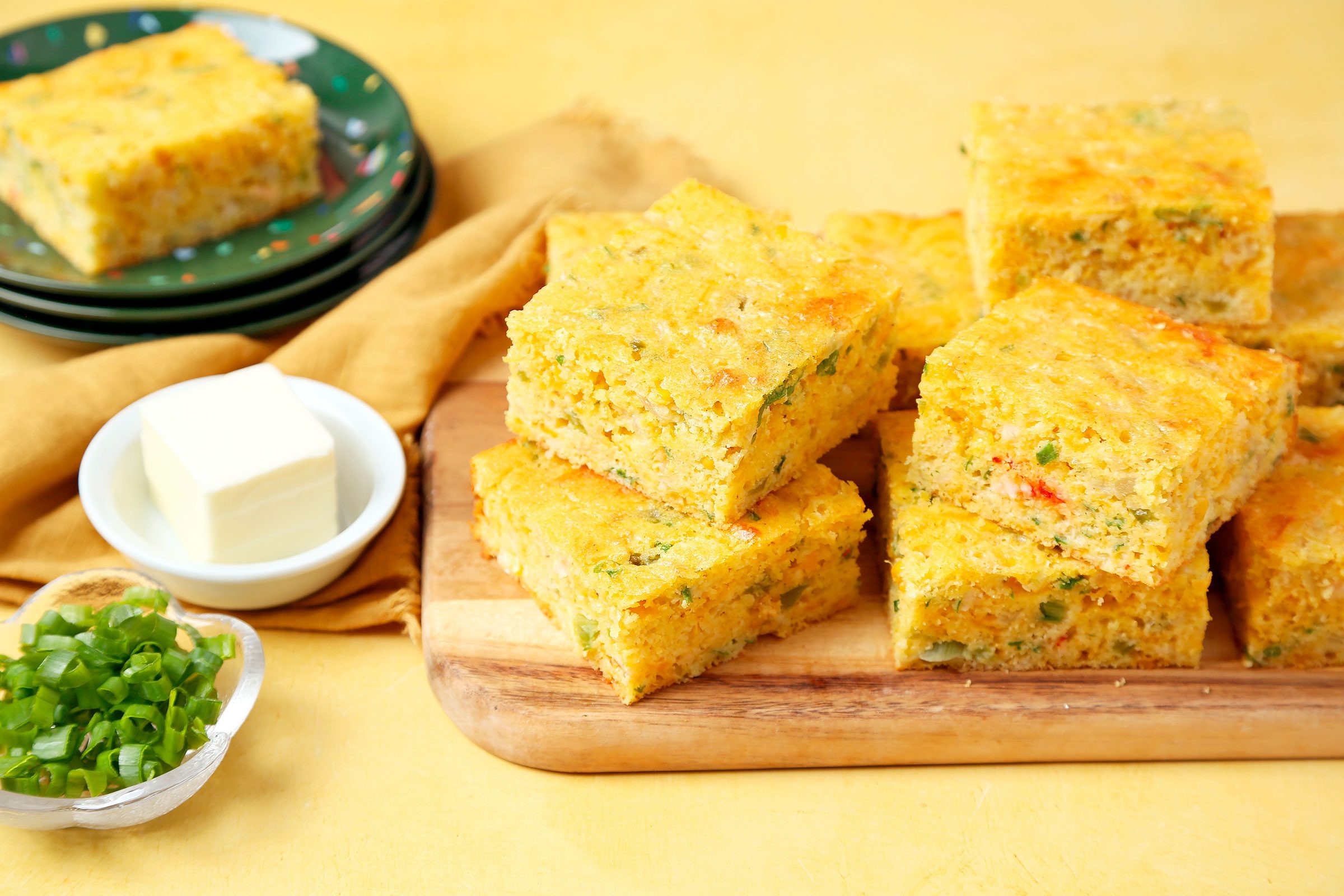 Crawfish Cornbread cut into pieces and placed on a wooden board