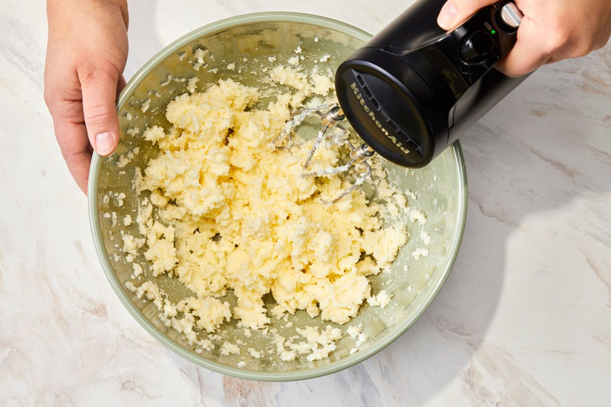 In a large bowl, cream the butter, cream cheese and sugar until light and fluffy,