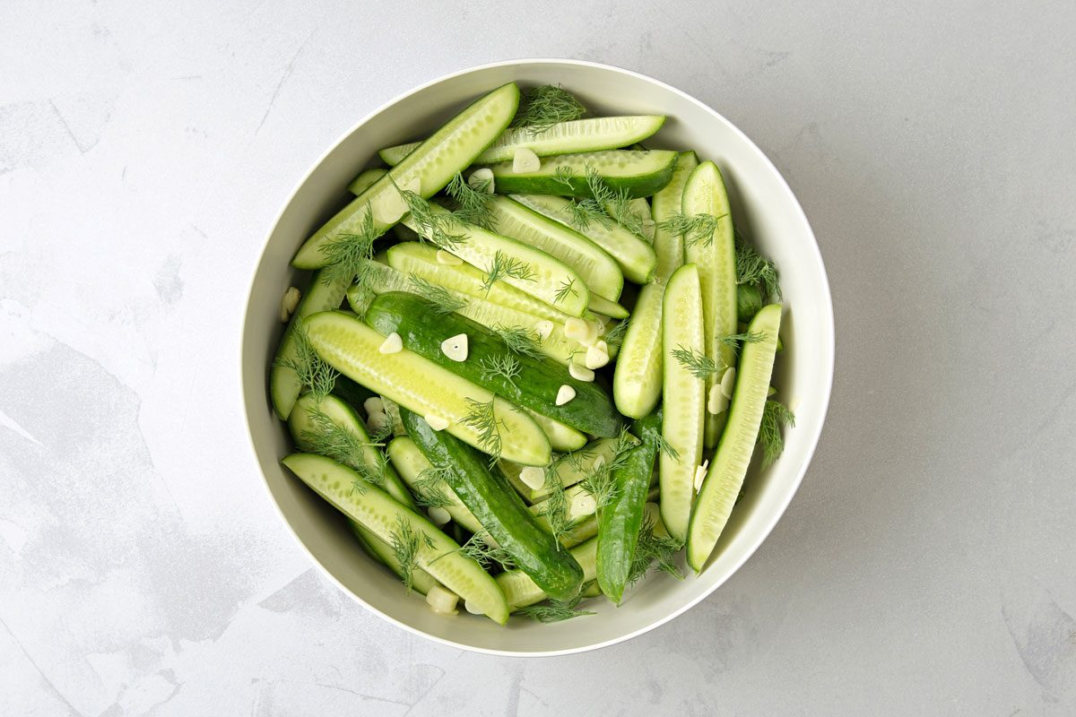 Cut the Cucumber and In a large bowl combine cucumbers; dill and garlic