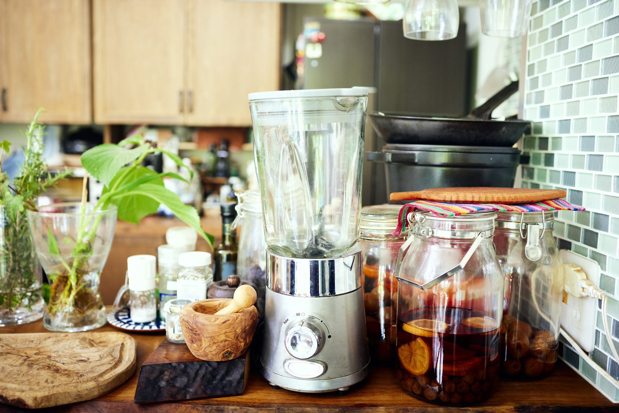 Fresh vegetables and greens, homemade drinks and condiments in the kitchen and on the counter