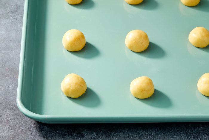 Roll dough into 1 inch balls; Place 2 inchs apart on ungreased baking sheets; Bake