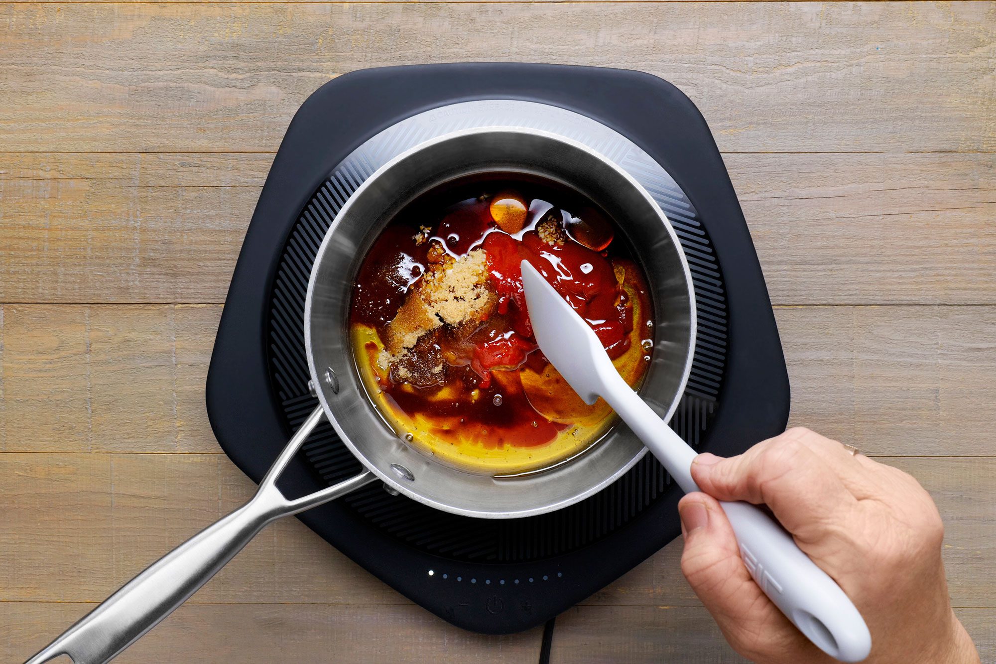 Stir ingredients in a saucepan on a hot plate