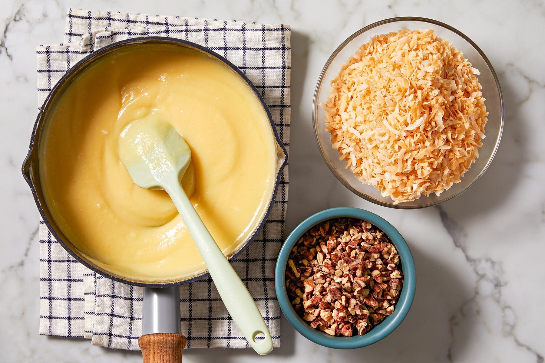 Overhead shot of egg mixture, coconut and pecans.