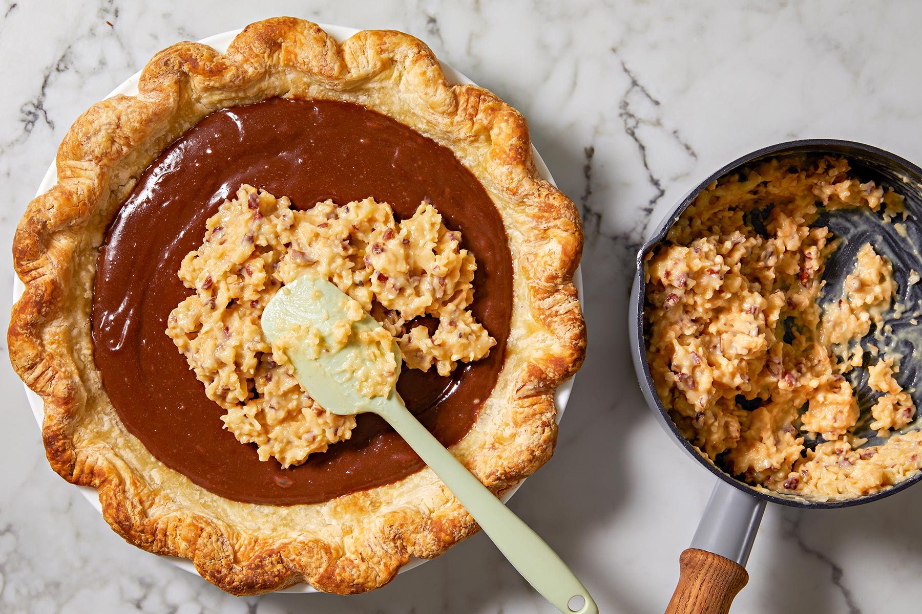 Pour pecan mixture over the pie with the chocolate filling with a spatula.
