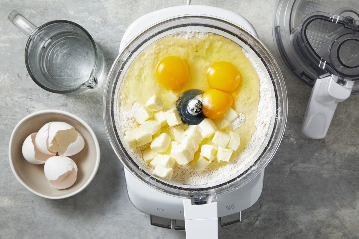 flour, salt, water, eggs and butter combined in a food processor
