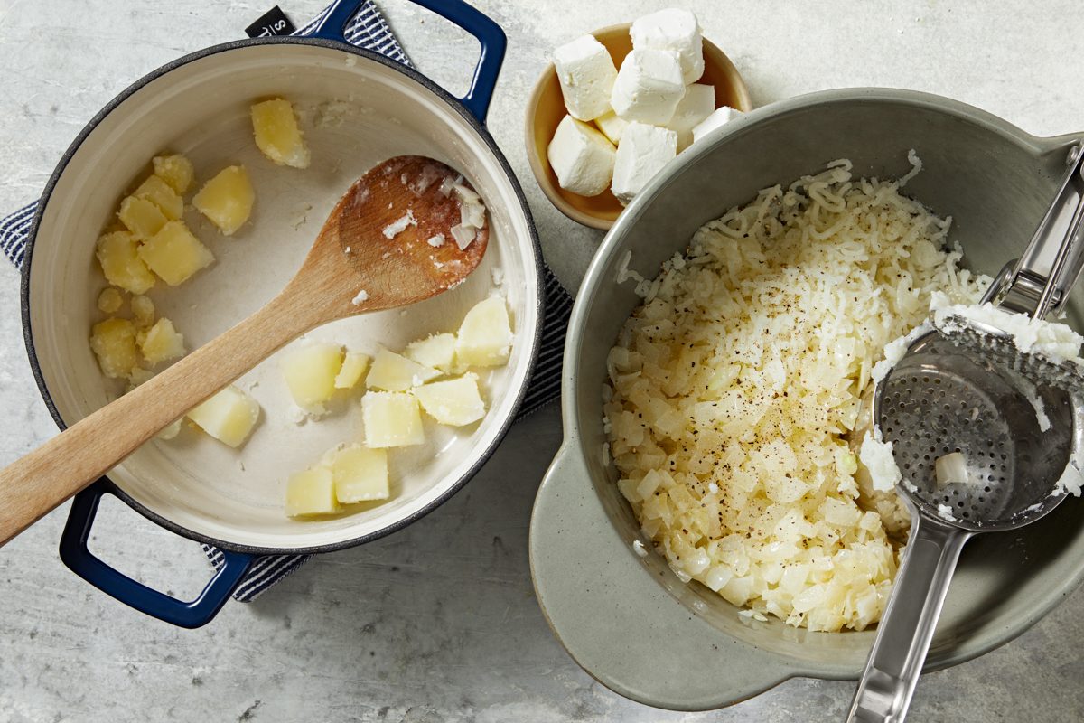 drained potatoes pressed through strainer into a large bowl