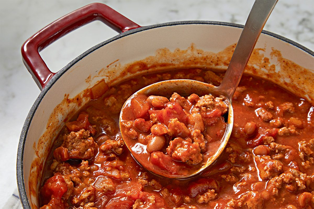 closeup shot of a pot of Kid’s Favorite Chili; a large ladle is resting in the pot