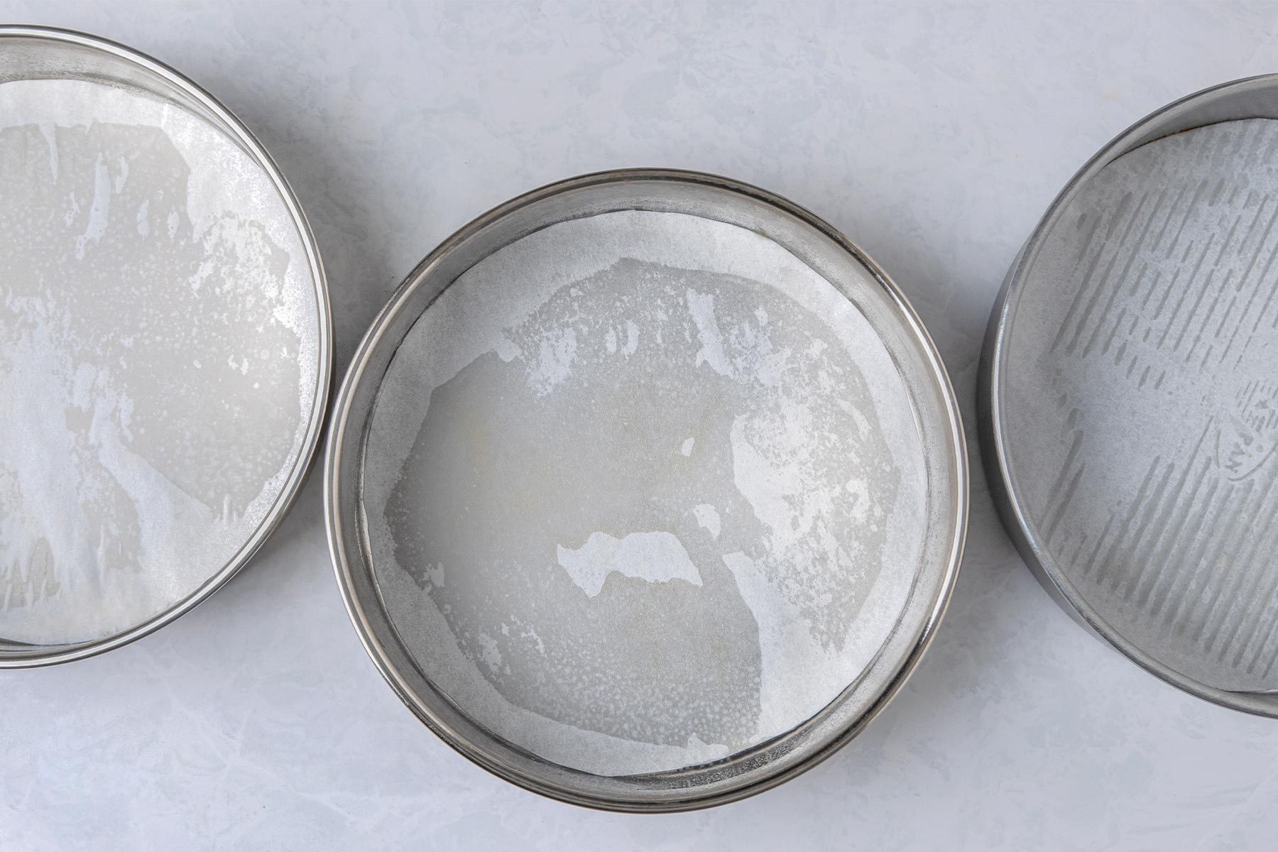 Line three 9-in. round baking pans with parchment paper.
