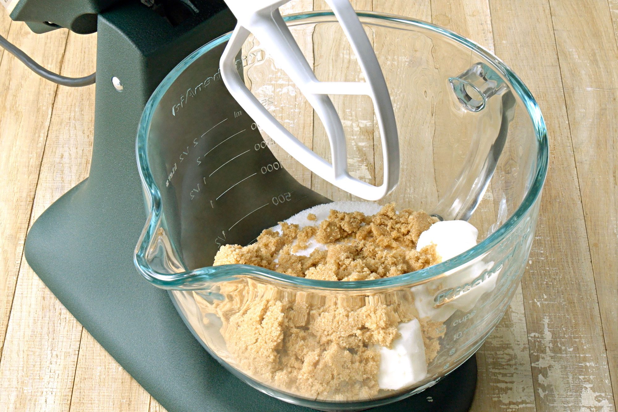 Close shot of a large bowl; cream the shortening and sugars until light and fluffy; wooden surface;