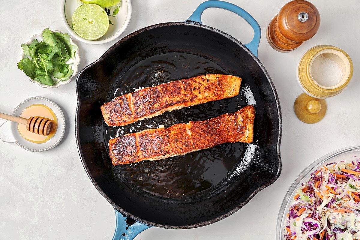 Salmon being cooked in a pan.