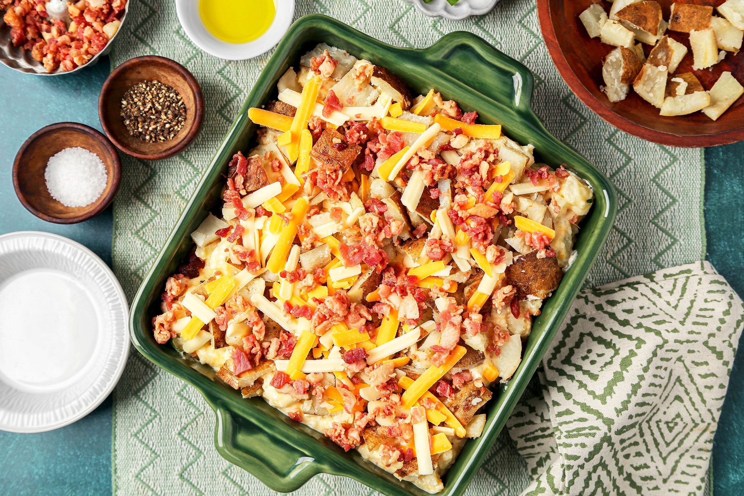 Loaded potato filling in a greased 1-1/2-quart baking dish with bacon and cheese on it