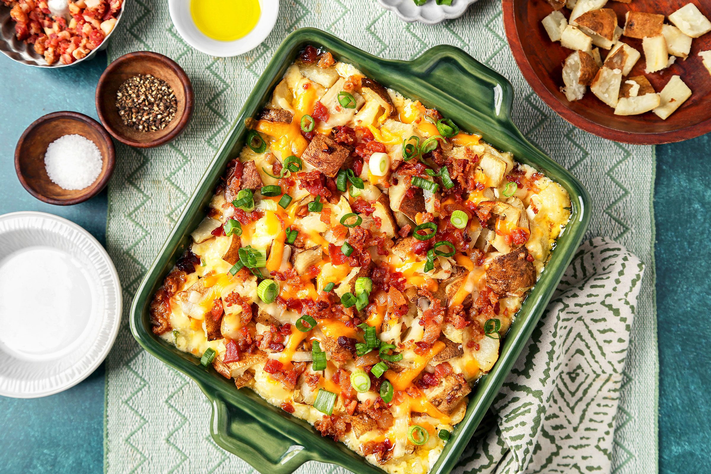 Twice Baked Potato Casserole with spring onions on it