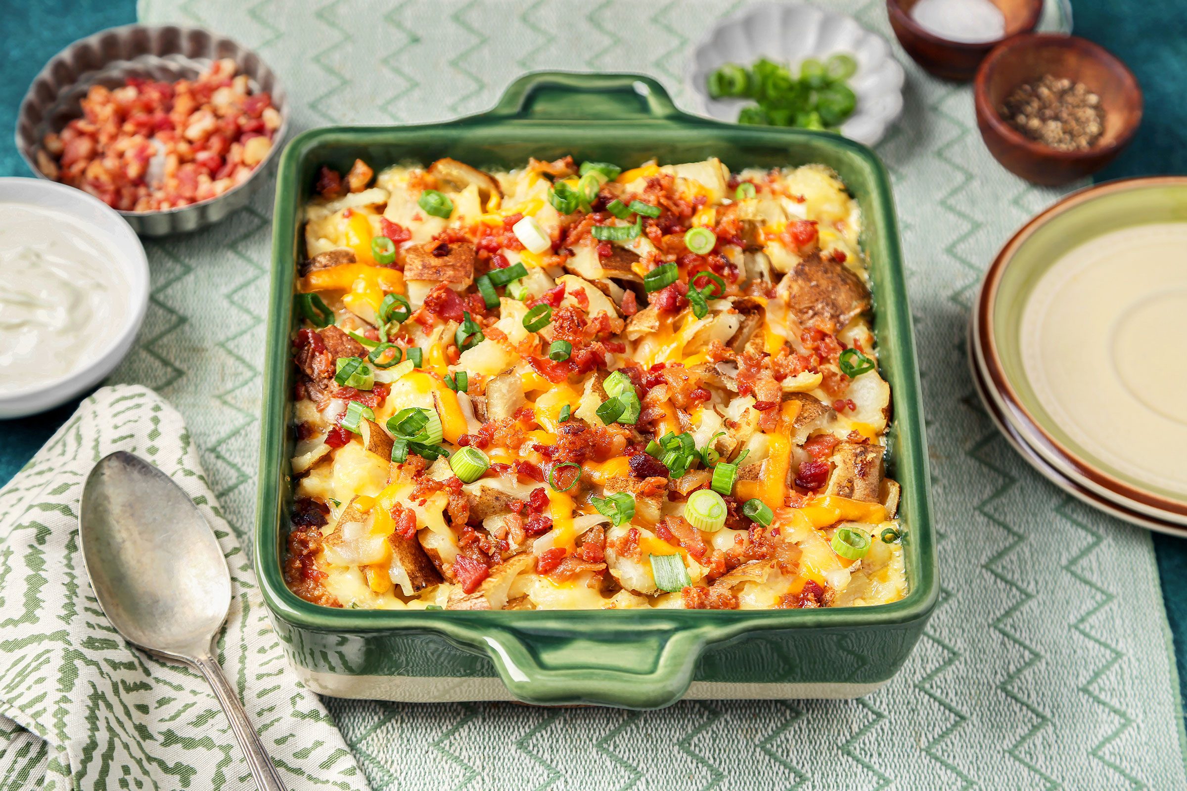 Twice Baked Potato Casserole with bacon and onions on side