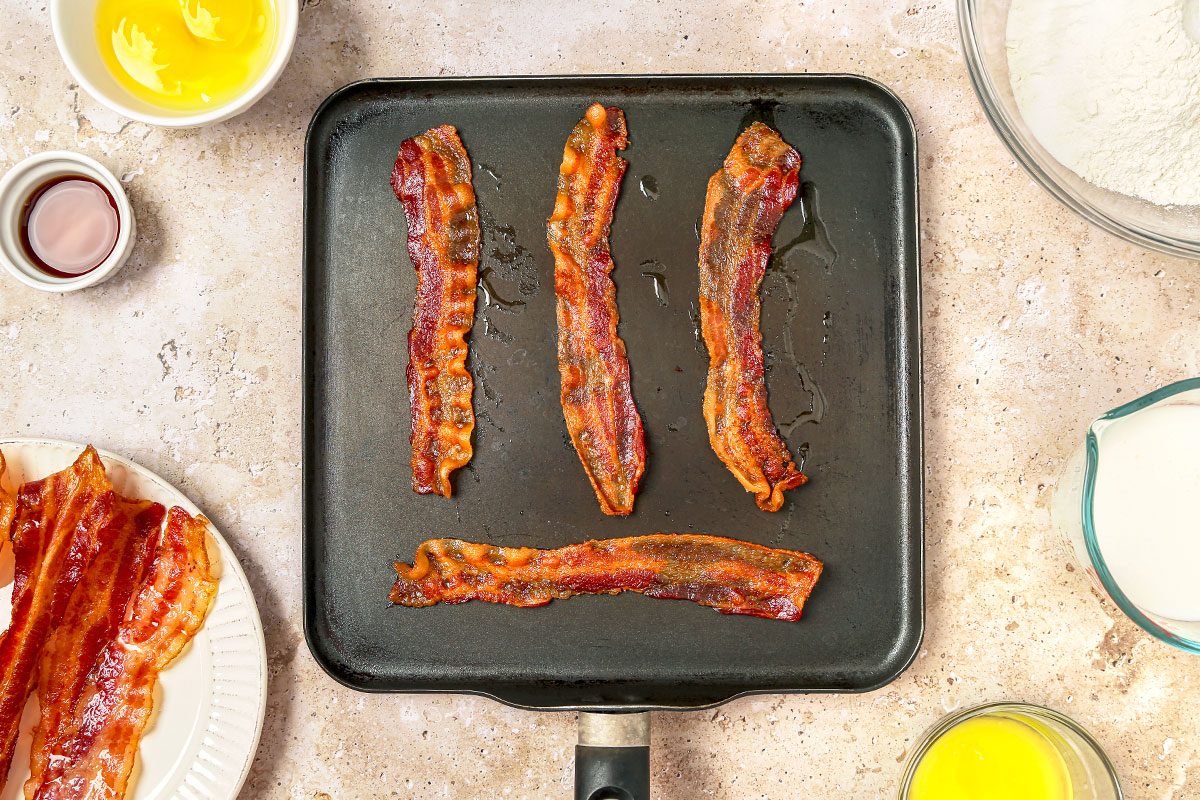 Bacon cooked in a large griddle pan