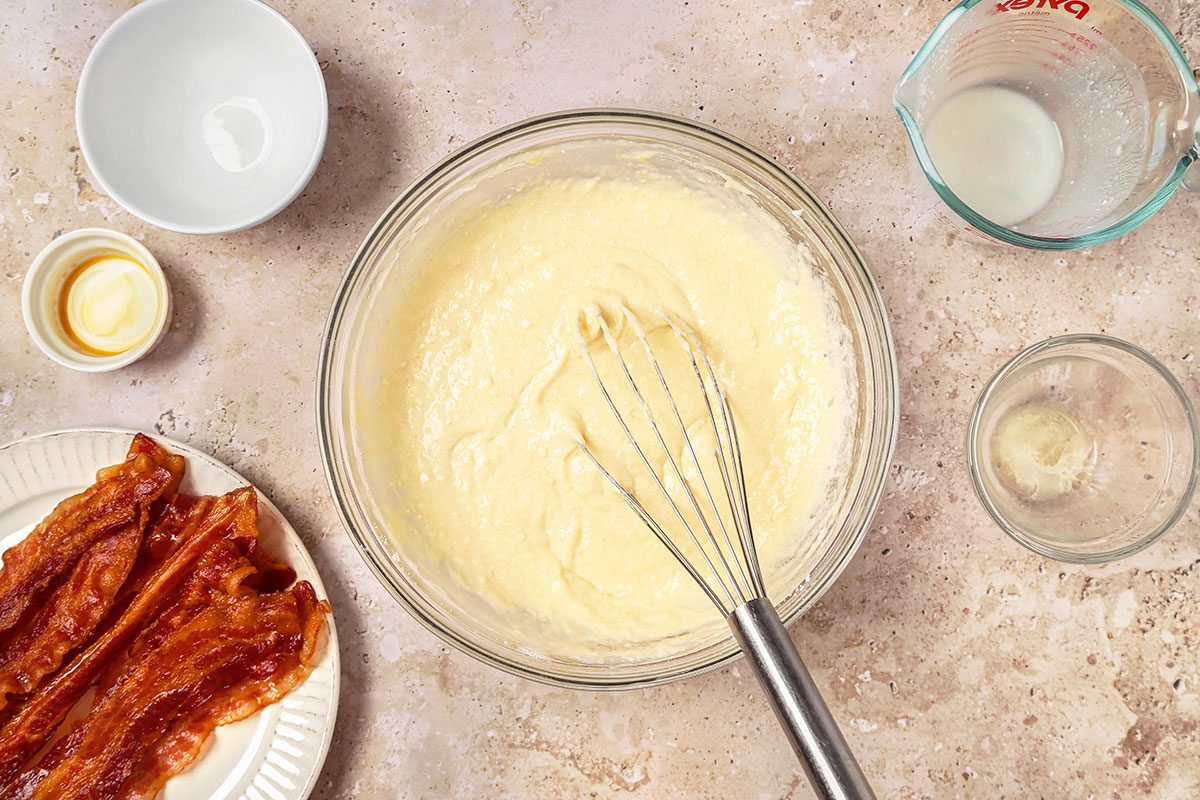 Batter mixed together with a whisk in a large mixing bowl