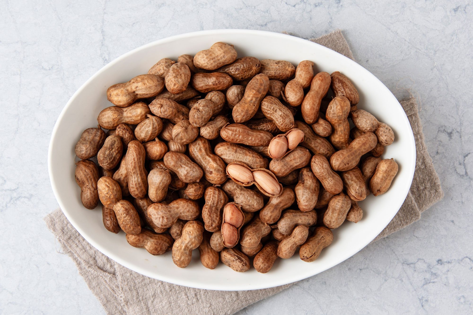 Overhead shot of Soft Boiled Peanut; serve on platter; napkin; marble surface;