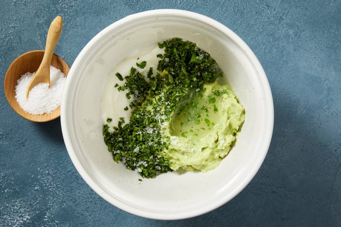 Overhead shot; For sauce; In a small bowl combine all crema ingredients until smooth; refrigerate until serving; Preheat oven to 450 degree; dark blue surface;