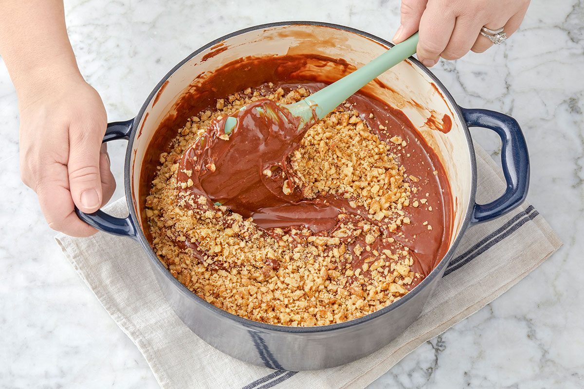 chocolate chips, marshmallows and chopped chocolate are mixing in a pan