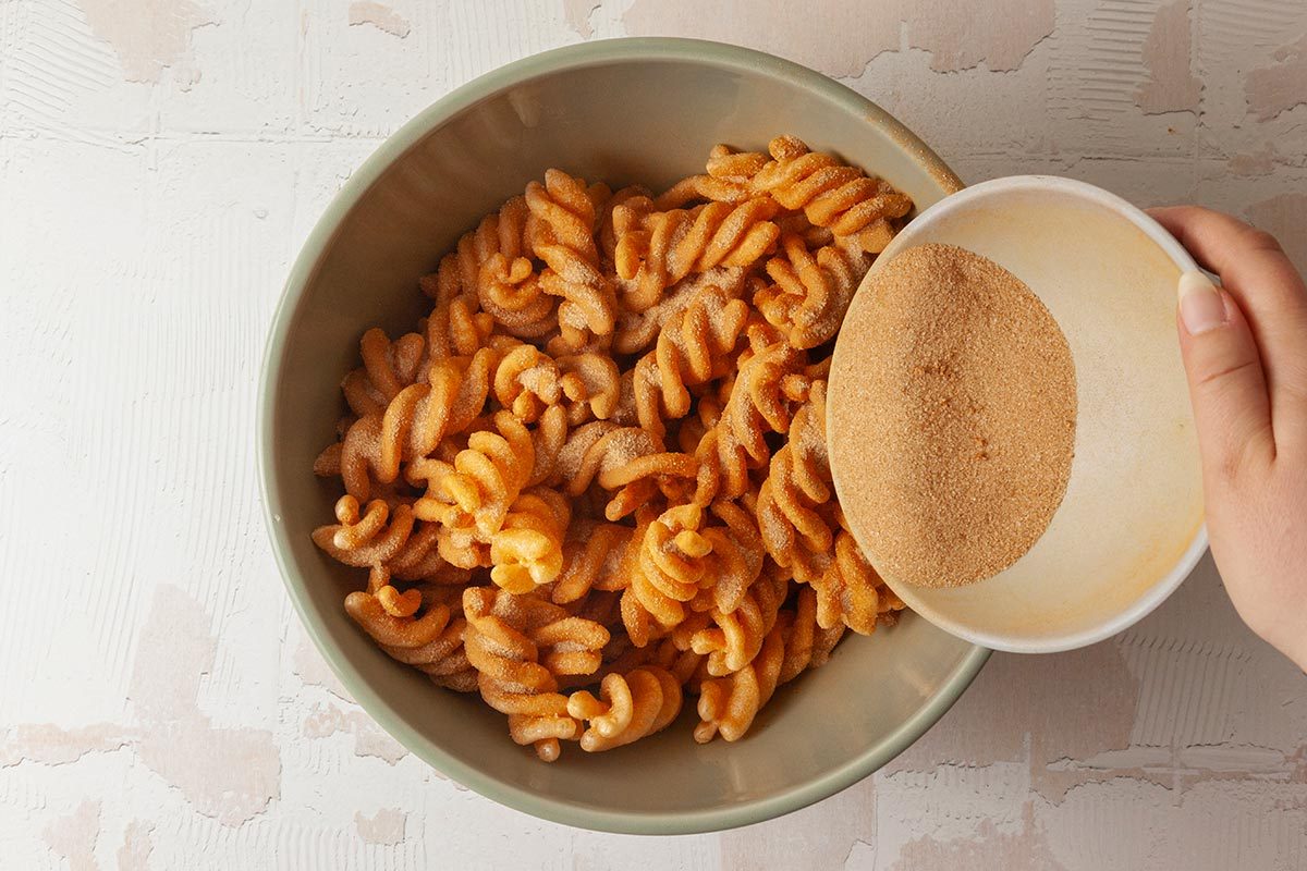 Cinammon, sugar mix are being poured into duros twist