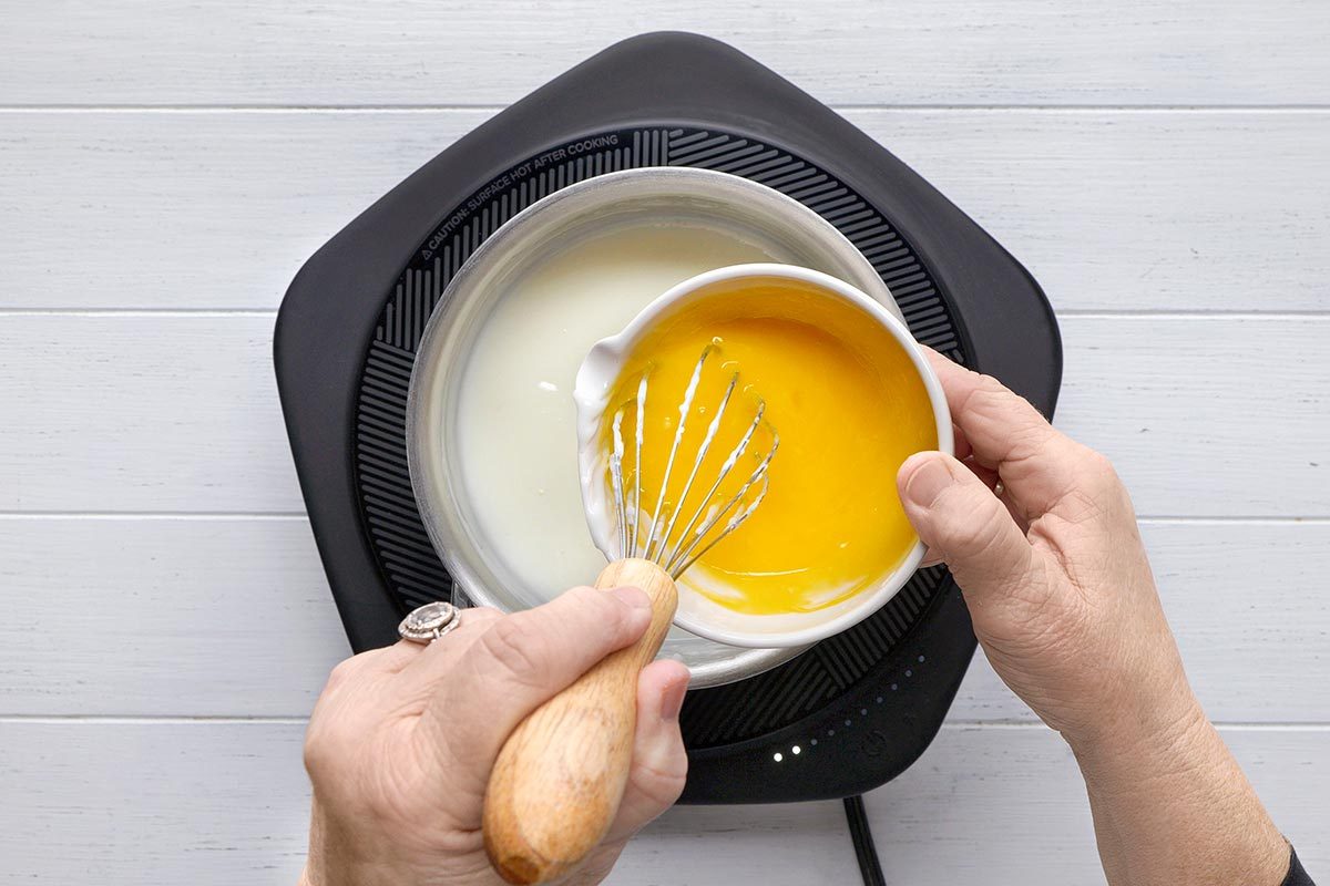 Egg yolks being mixed in a small bowl