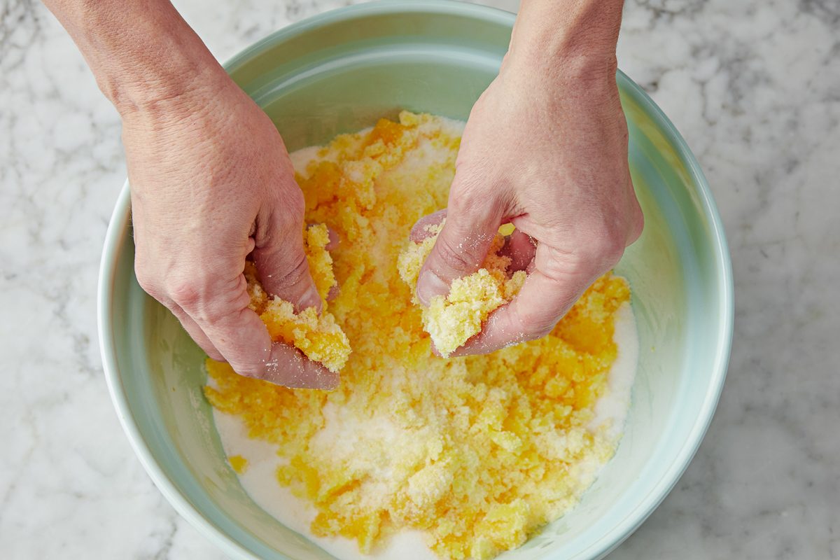 hands combining sugar mixture and colored water