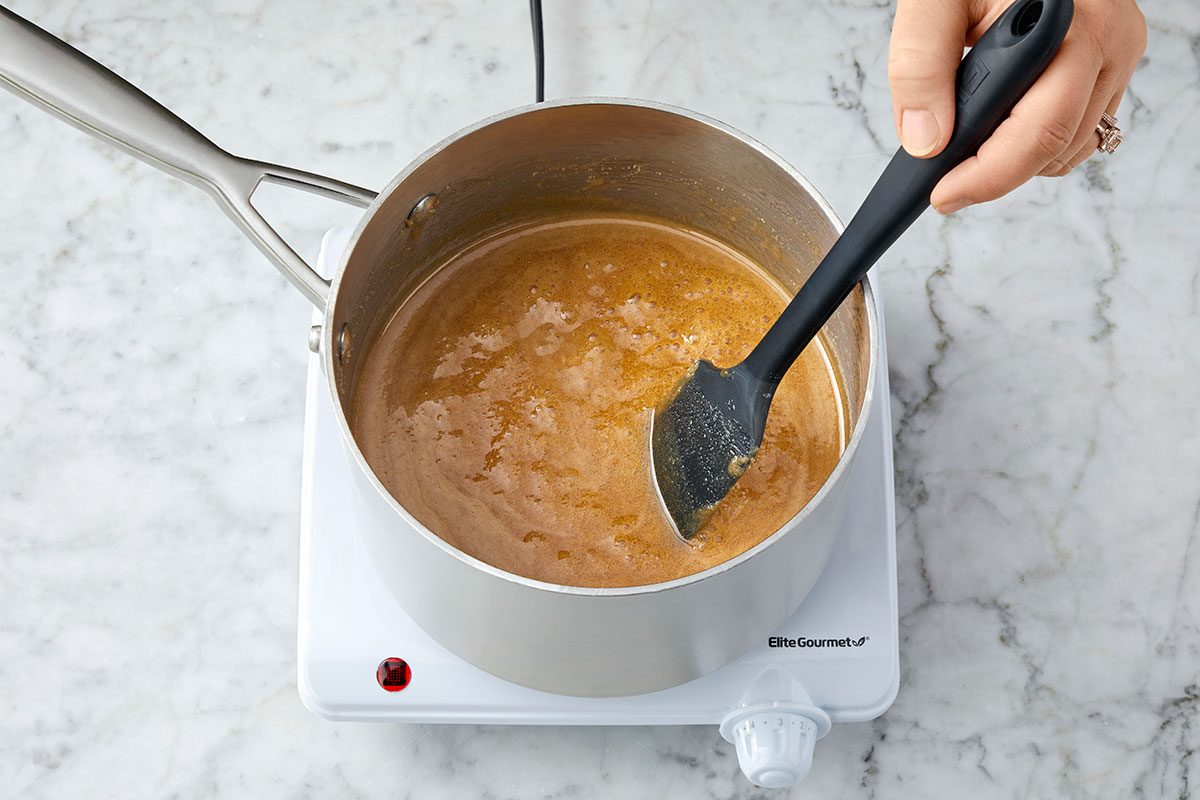 Sugar, milk, corn syrup and salt are mixed and heated in a pan