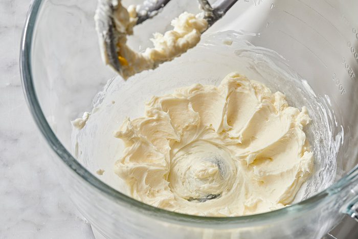 Close up shot; For frosting, in a small bowl beat cream cheese and butter until fluffy