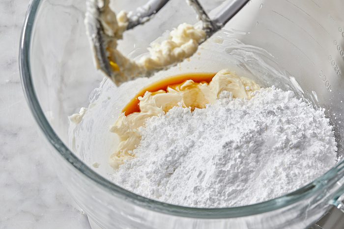 Close up shot of add confectioners’ sugar and vanilla