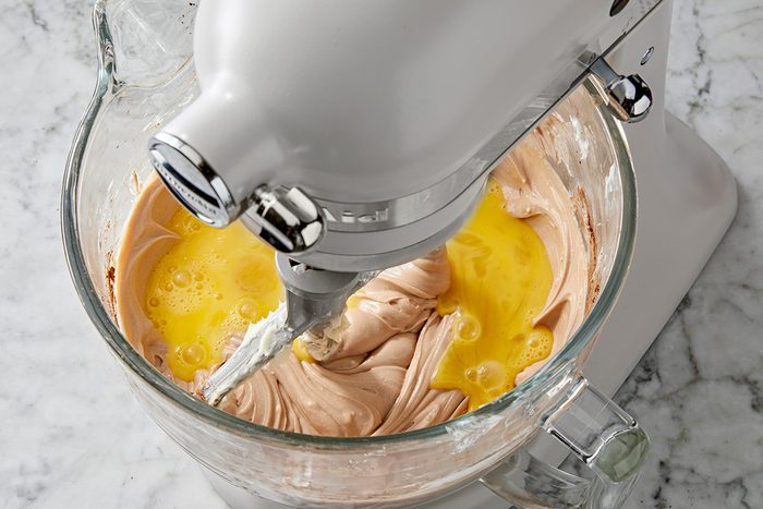 Close shot of add eggs; beat on low speed just until blended; marble surface
