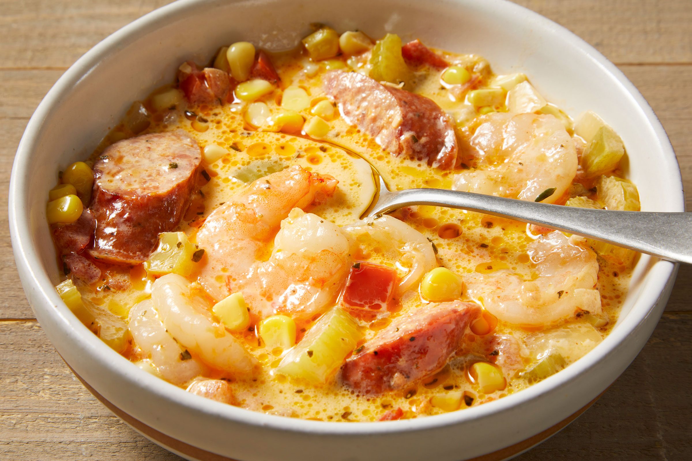 Shrimp And Sausage Soup in a bowl with a spoon in it
