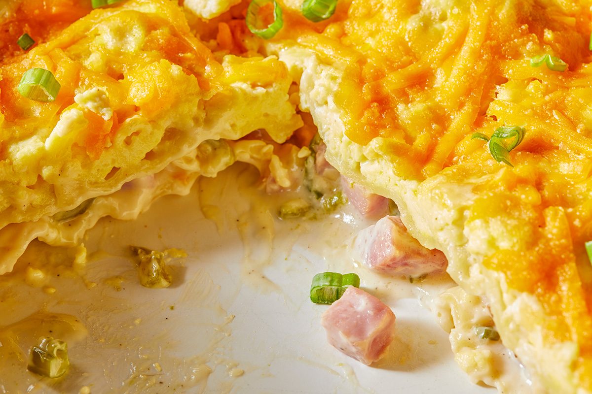 Close-up shot of Brunch Lasagna; in a baking pan; top with sliced green onions