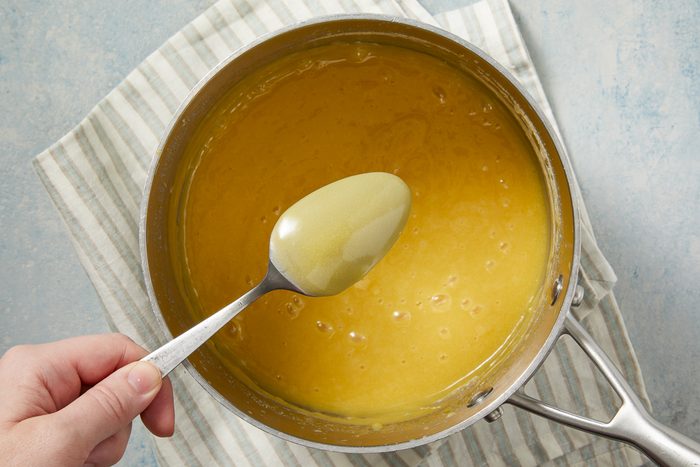 spoon holding up cooked cream mixture