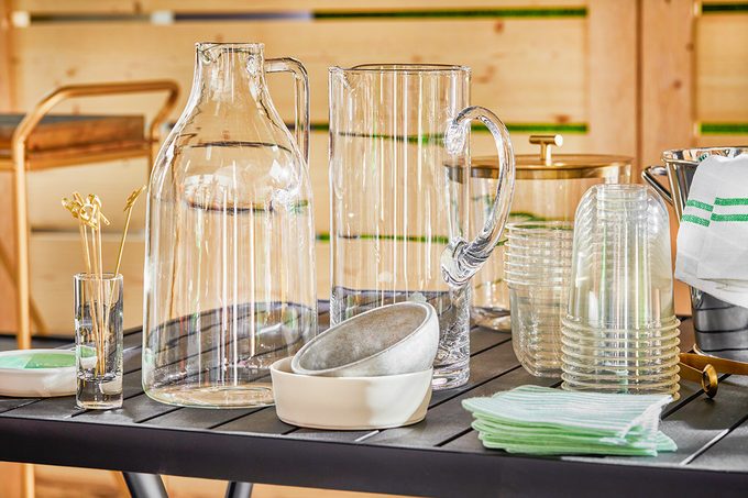 Various serveware are on table for outdoor drink station setup