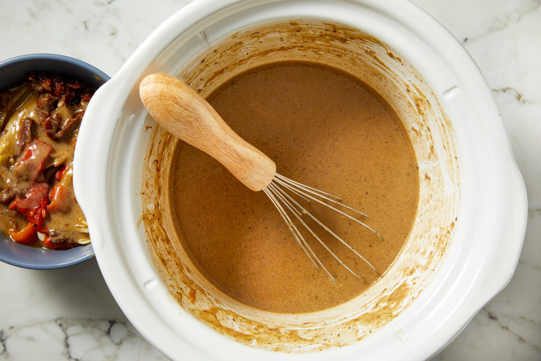 Liquid whisked into creamy gravy, vegetables stirred back in.