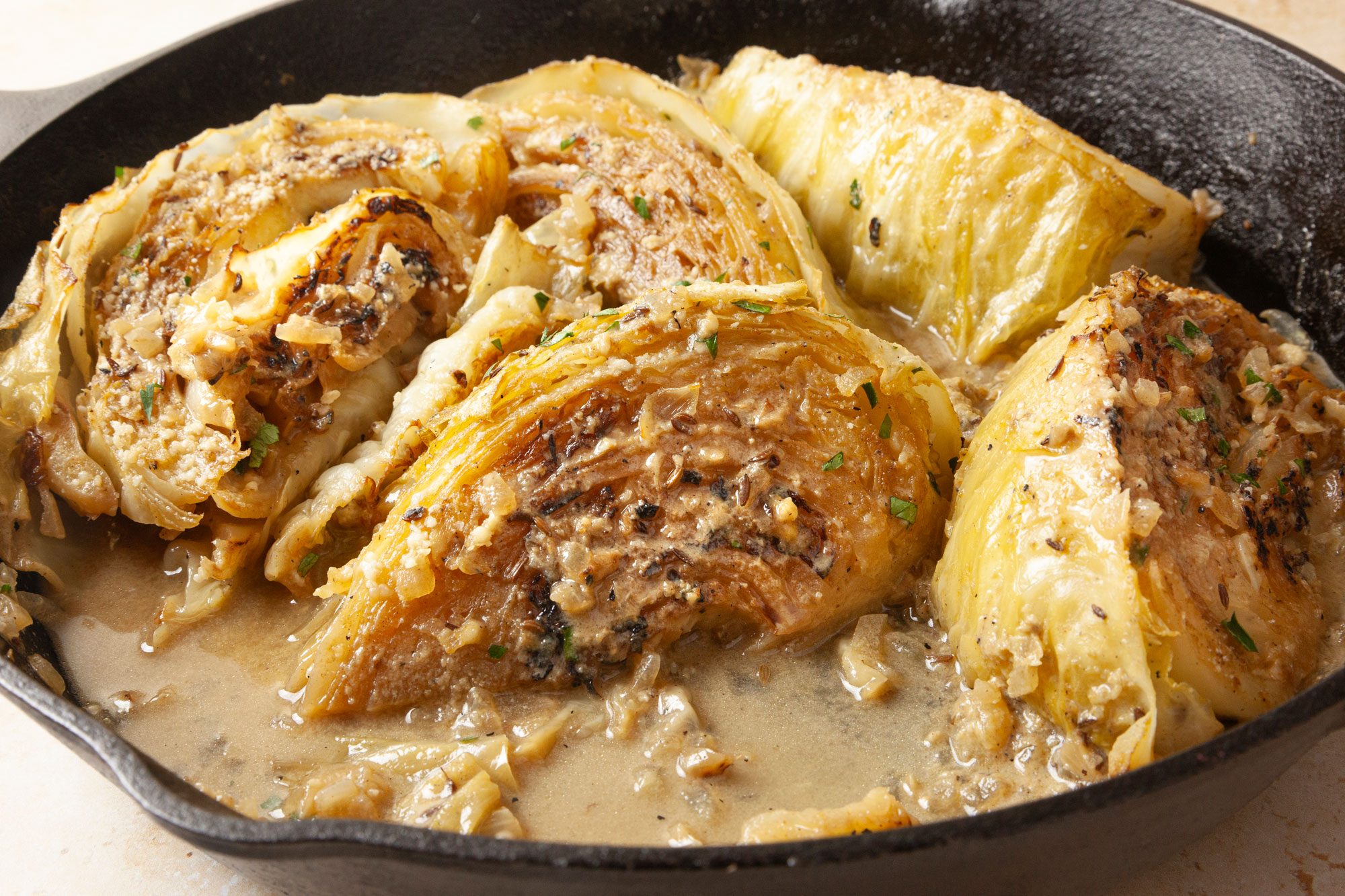 closeup shot of Melting Cabbage is presented in a cast iron skillet