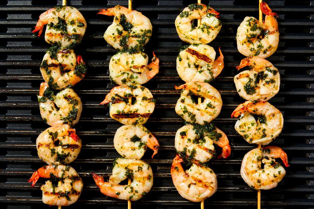 Thread shrimp onto metal or soaked wooden skewers; brush with remaining basil mixture. Grill, covered,